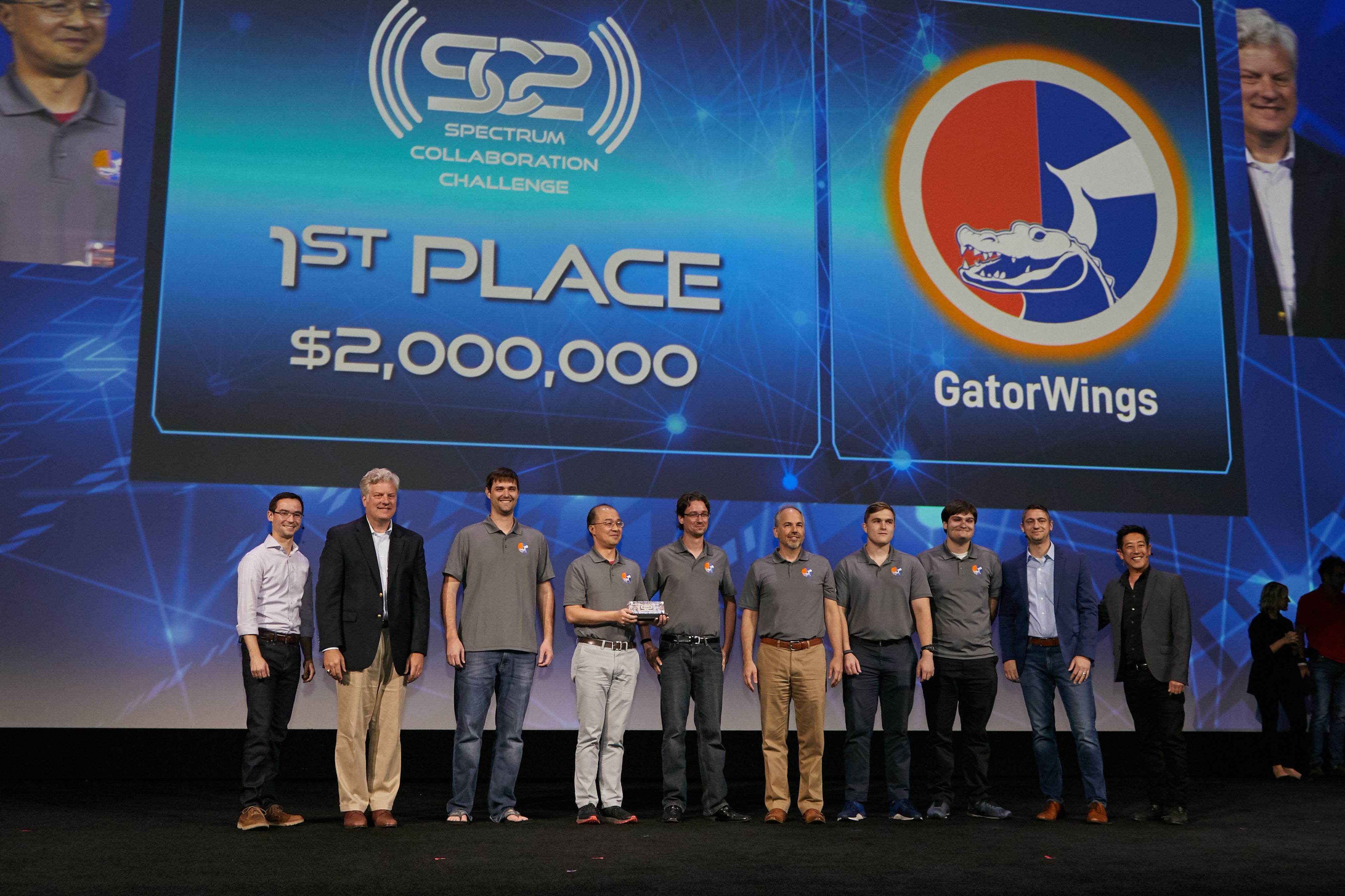 Picture of Team GatorWings accepting the 1st place prize at the DARPA Spectrum Collaboration Challenge